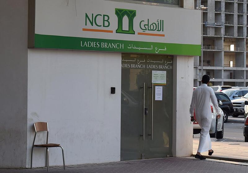 S&P lowered its long-term counterparty credit ratings on National Commercial Bank, among other Saudi banks. Fayez Nureldine / AFP