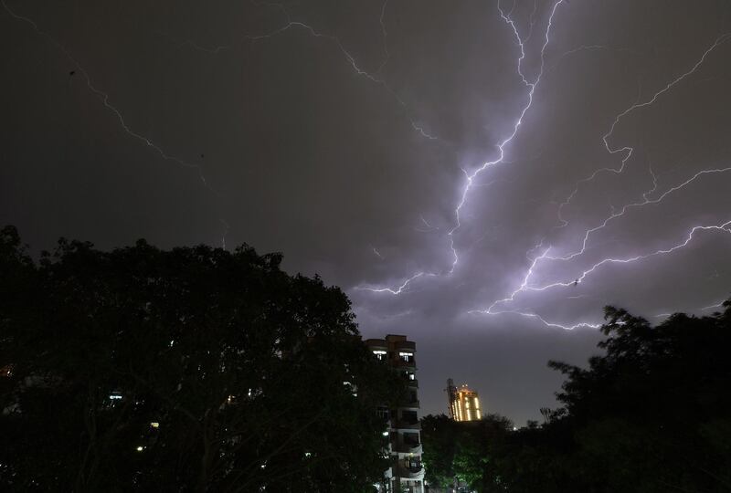 Lightning strikes over residential apartments during storms on the outskirts of the Indian capital New Delhi in May 2018.