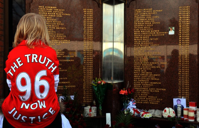 A child wears a jersey bearing the words  "Justice for the 96" in front of the Hillsborough Memorial at Liverpool FC's Anfield football ground in Liverpool, England, on April 15, 2013, where supporters gathered for the 24th anniversary of the 1989 Hillsborough disaster where 96 Liverpool fans were crushed to death at Hillsborough Stadium.  AFP