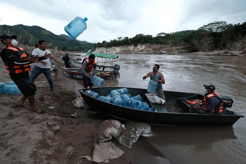 People from San Rafael colony prepare for water shortage as they cross the Ulua river to evacuate before the arrival of hurricane Iota in Santa Barbara, Honduras. Getty