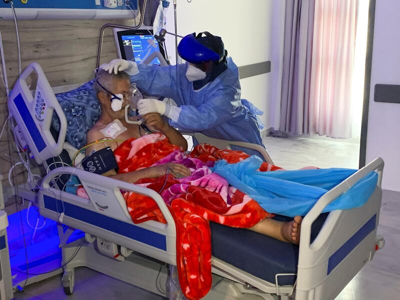 A nurse in a protective suit attends to a patient in Misrata, Libya. Reuters