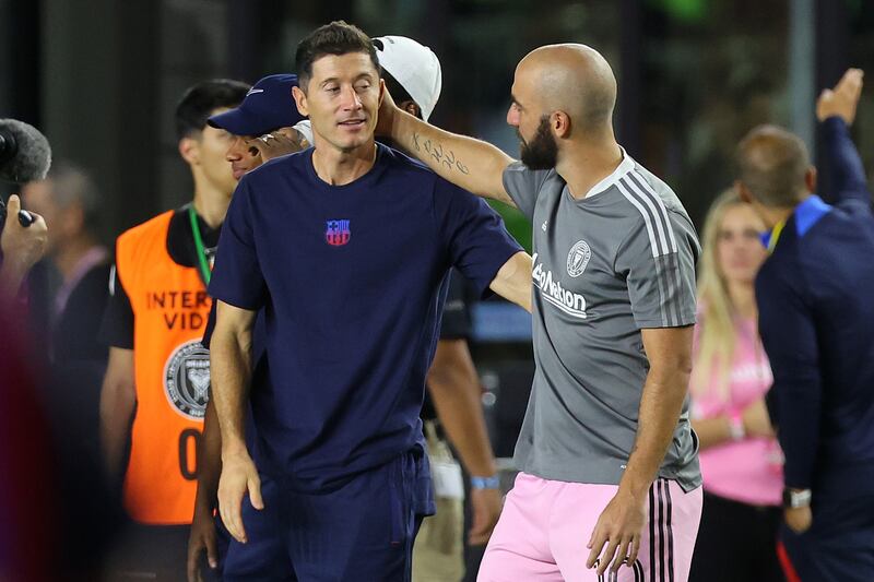 Barcelona striker Robert Lewandowski talks to Gonzalo Higuain of Inter Miami. Getty
