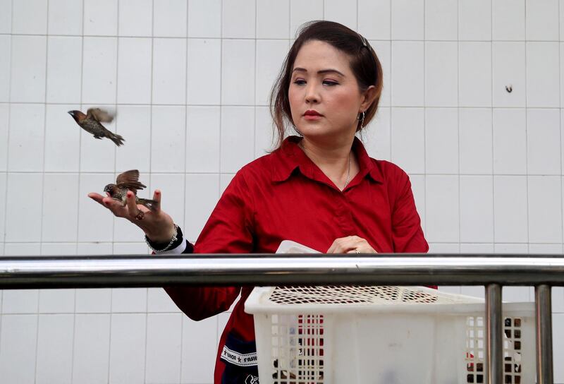 An Indonesian woman frees a bird as she prays during celebrations at the Gayatri temple in Cilodong, West Java. EPA