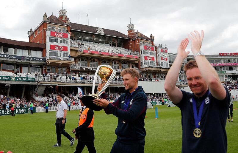 England's Eoin Morgan, right, and England's Joe Root celebrate with the trophy at the Oval in London, one day after they won the Cricket World Cup in a final match against New Zealand. AP Photo