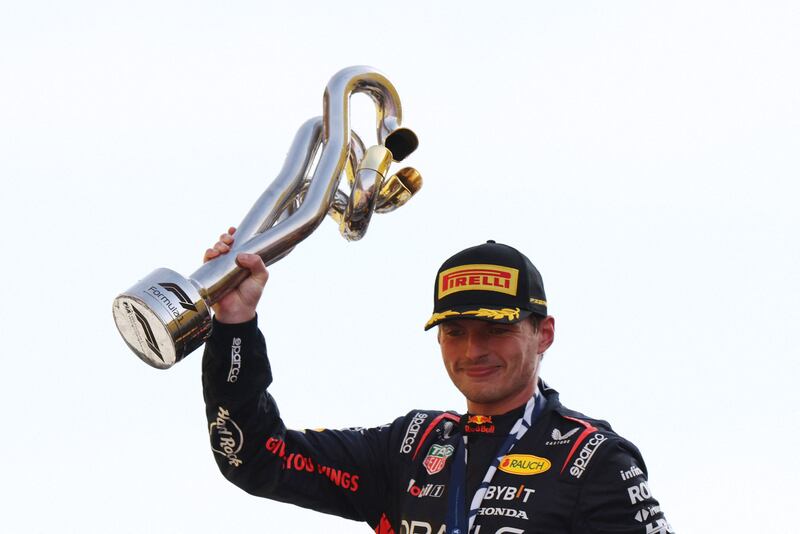 Red Bull's Max Verstappen celebrates with the trophy after winning the Italian Grand Prix at Monza, Italy on September 3, 2023, to set a new record of 10 wins in a row. Reuters