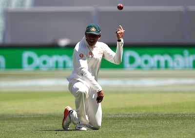Australia's Usman Khawaja celebrates after taking a catch to dismiss India's Virat Kohli during the first cricket test between Australia and India in Adelaide, Australia,Thursday, Dec. 6, 2018. (AP Photo/James Elsby)