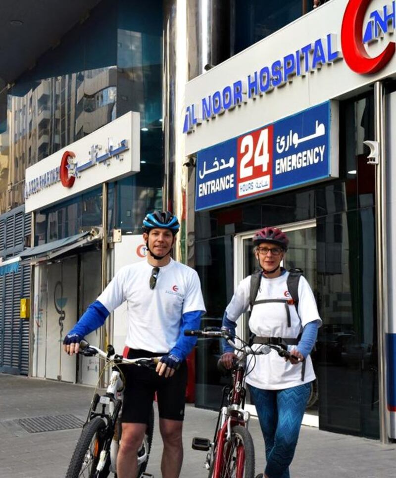 Ronald Lavater, chief executive of Al Noor Hospitals Group and Donna Lunn, chief information officer arrive at Al Noor Hospital after participating in the cycle to work campaign. Courtesy Al Noor Hospitals