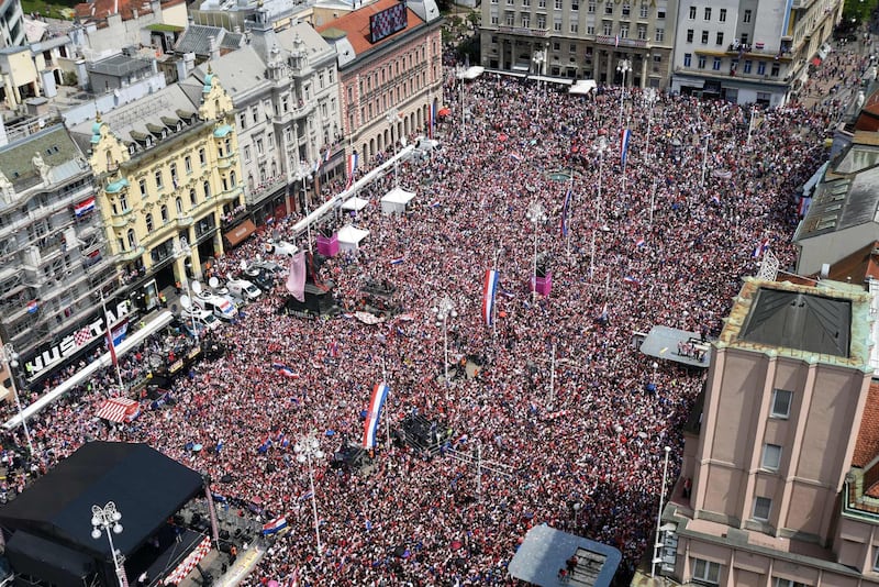 People gather for a 'heroes' welcome' in tribute to the Croatian national football team. Denis Lovrovic / AFP