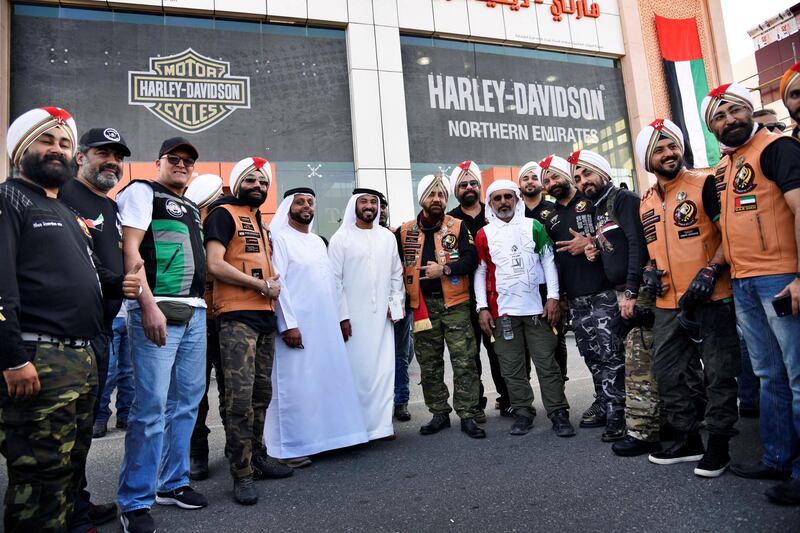Gurnam Singh, center right, founder of Sikh Bikers group, H.H. Sheikh Suhail Bin Hasher Bin Dalmook, center, an avid biker in the UAE, along with other members of the bikers' groups pose for a photograph outside the Harley Davidson showroom during the 48th National Rally "Love Zayed" in Sharjah, UAE, Friday, Nov. 29, 2019. Shruti Jain The National