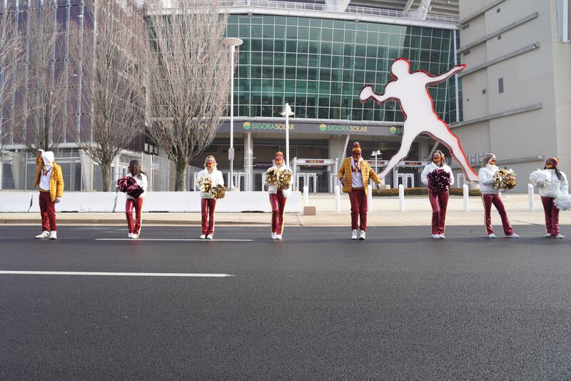 Cheerleaders don the new Washington Commanders logo outside of Fedex Field. Willy Lowry / The National.