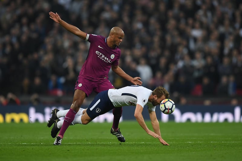 Tottenham striker Harry Kane is challenged by Vincent Kompany. Shaun Botterill / Getty Images