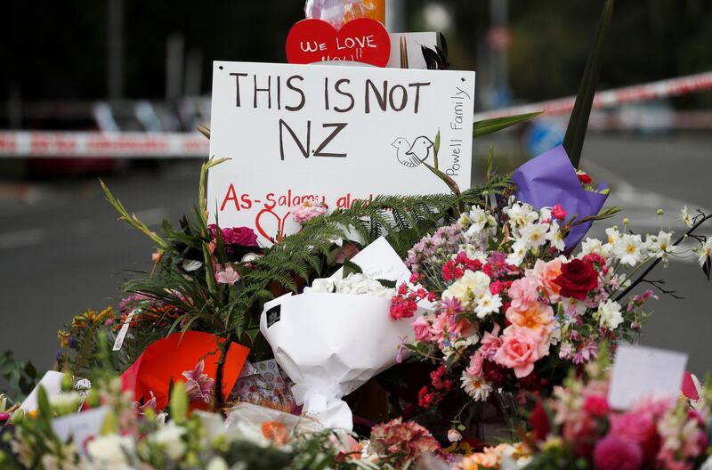 Flowers and signs are seen at a memorial as a tribute to victims of the mosque attacks, near Linwood mosque in Christchurch, New Zealand, March 16, 2019. REUTERS/Edgar Su