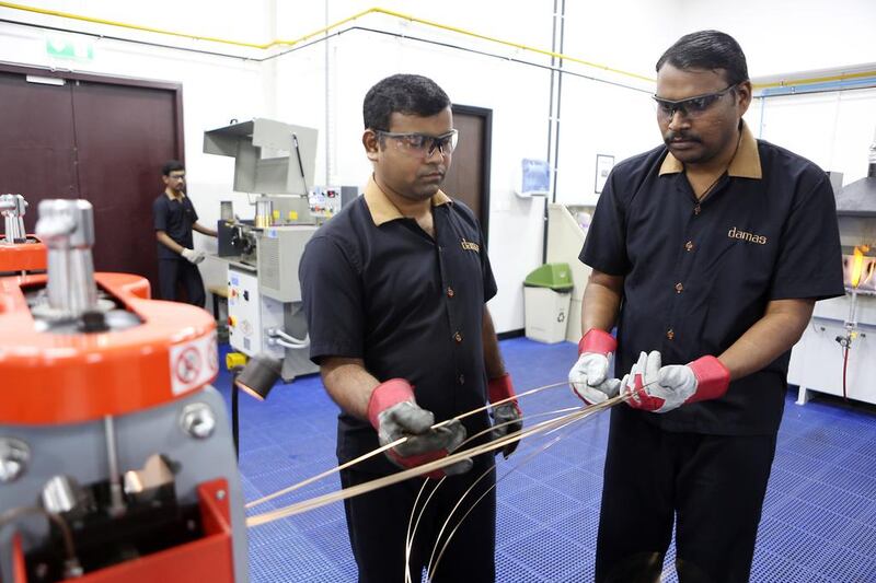 Damas workers prepare gold wires for jewellery making. Pawan Singh / The National