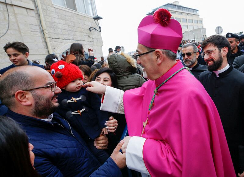 Pierbattista Pizzaballa greets people as he arrives to attend Christmas celebrations in Bethlehem. Reuters