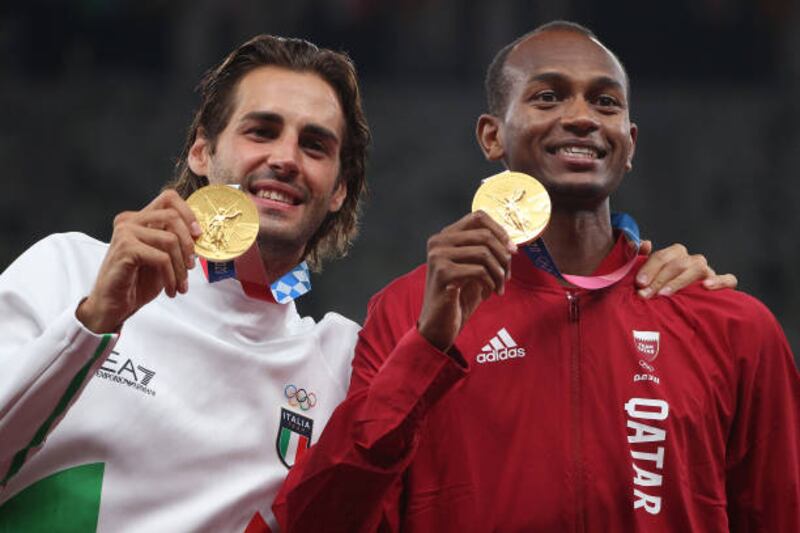 Joint gold medallists Mutaz Essa Barshim of Team Qatar and Gianmarco Tamberi of Team Italy celebrate on the podium during the medal ceremony for the Men's High Jump on day ten of the Tokyo 2020 Olympic Games.  Getty