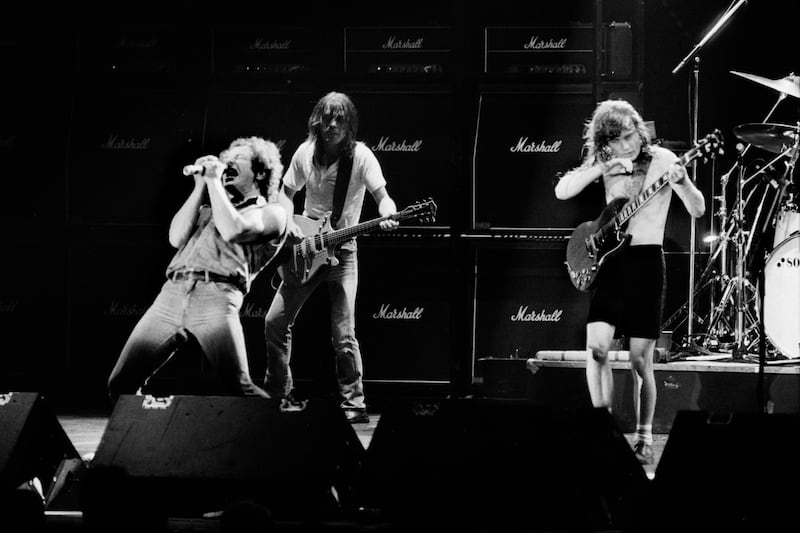 Brian Johnson belts out the vocals alongside AC/DC guitarists Malcolm and Angus Young at the Palais Omnisport, Paris, in 1984. AFP