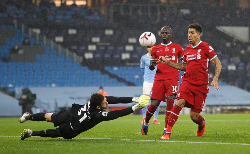 City goalkeeper Ederson saves a shot from Roberto Firmino of Liverpool. Getty