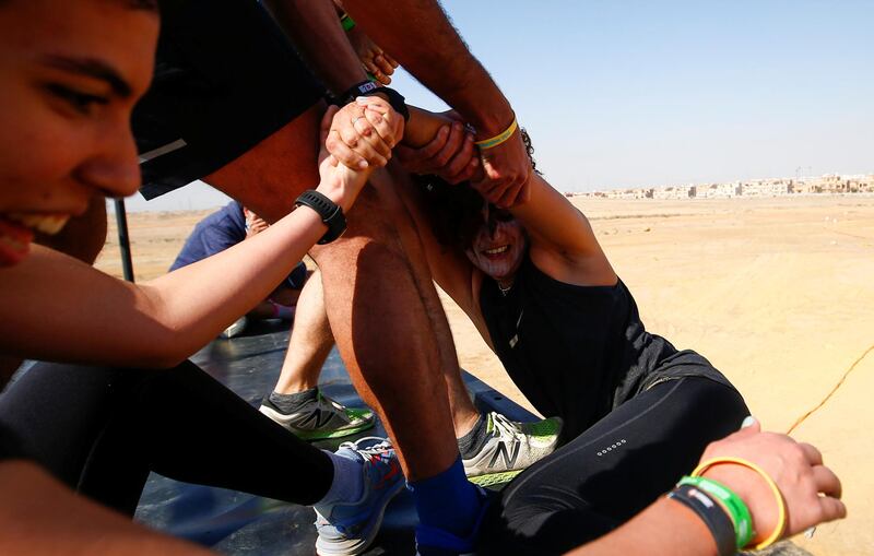 Competitors feel the strain, during Egypt's Tough Mudder event. Organisers tell participants that if an obstacle is too daunting, then go round it  – 'without penalty or shame'. Reuters
