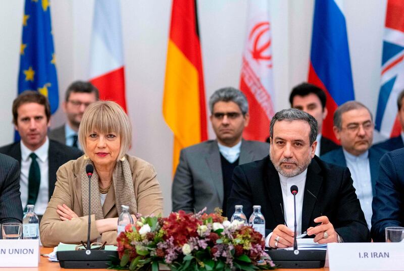 Iranian political deputy at the Ministry of Foreign Affairs of Iran Abbas Araghchi (C-R), and the Secretary General of the European Union External Action Service (EEAS) German  Secretary General of the European External Action Service (EEAS) Helga Maria Schmid attend a meeting of the Joint Commission on Iran's nuclear program (JCPOA) at EU Delegation to the International Organizations office in Vienna, Austria, on December 6, 2019.  / AFP / JOE KLAMAR
