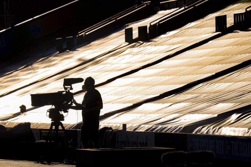 A cameraman is silhouetted against the empty stands during the English Premier League match between Burnley and Watford at the Turf Moor Stadium in Burnley. AP photo