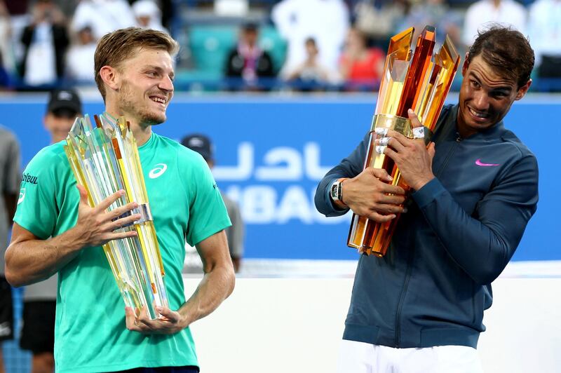 Spain's Rafael Nadal (R) poses with the winners trophy next to Belgium's David Goffin (L) after their final match of the Mubadala World Tennis Championship 2016 in Abu Dhabi on December 31, 2016. - Nadal won 6-4 and 7-6. (Photo by Nezar Balout / AFP)