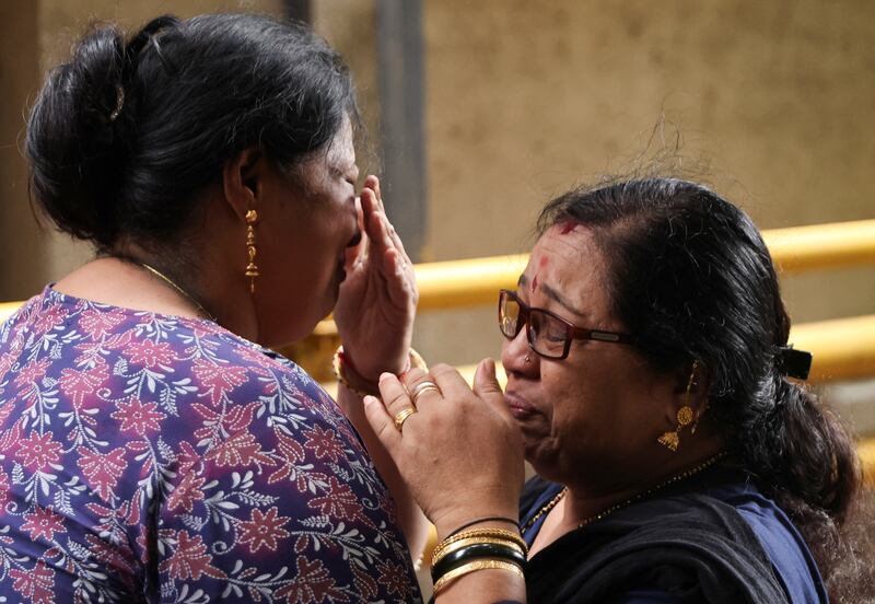 Relatives mourn the death of 18-year-old Tisha Chogule after a fire engulfed a residential building in Mumbai. Reuters