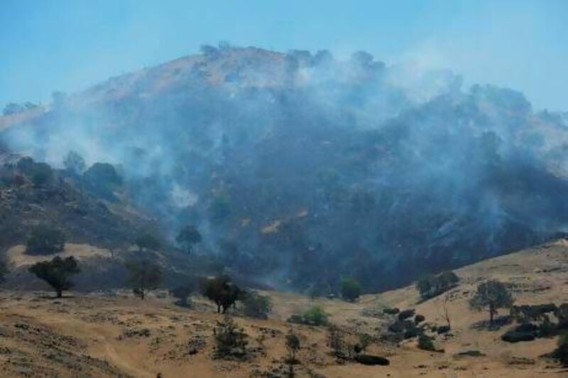 A scrubfire burns up a hillside south of Bookham, near Yass in southern New South Wales. After two days of cooler weather, heat and high winds returned to much of the country.