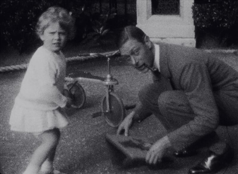 Princess Elizabeth with her father, then Duke of York, in the garden of their home 145 Piccadilly, London, in 1930.