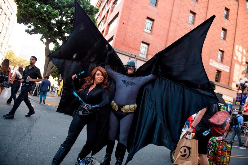 Cosplayers portraying Batman and the Black Widow strike a pose in the street outside the San Diego Convention Center. AFP
