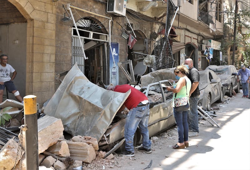 People check damaged vehicles.  EPA