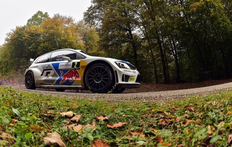 Finland's driver Jari-Matti Latvala and co-driver Miikka Anttila to victory in their Volkswagen Polo R at the Rally of France-Alsace, the 11th event of the 13-leg World Rally Championship, on October 5, 2014.  AFP / PATRICK HERTZOG

