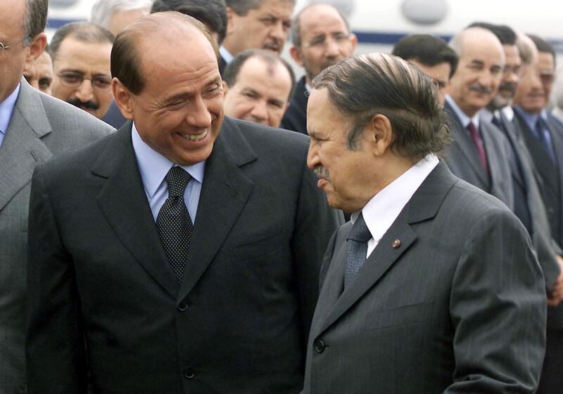 Former Algerian president Abdelaziz Bouteflika, right, welcomes Mr Berlusconi for a two-day visit aimed at boosting economic ties between the two countries, in June 2002. AFP