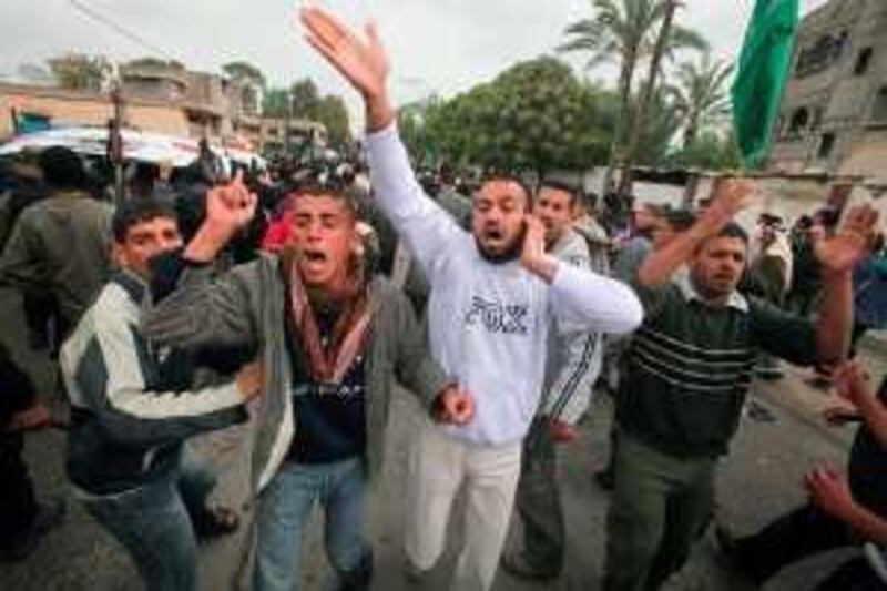 Palestinians shout slogans during the funeral of Haytham Arafat in Khan Younis in the southern Gaza Strip March 27, 2010. Israeli troops and tanks left the Gaza Strip on Saturday, witnesses said, ending an incursion into the Hamas-ruled enclave made after the bloodiest clash in 14 months killed two soldiers and at least one Palestinian. REUTERS/Suhaib Salem (GAZA - Tags: POLITICS CIVIL UNREST) *** Local Caption ***  SJS01_PALESTINIANS-_0327_11.JPG