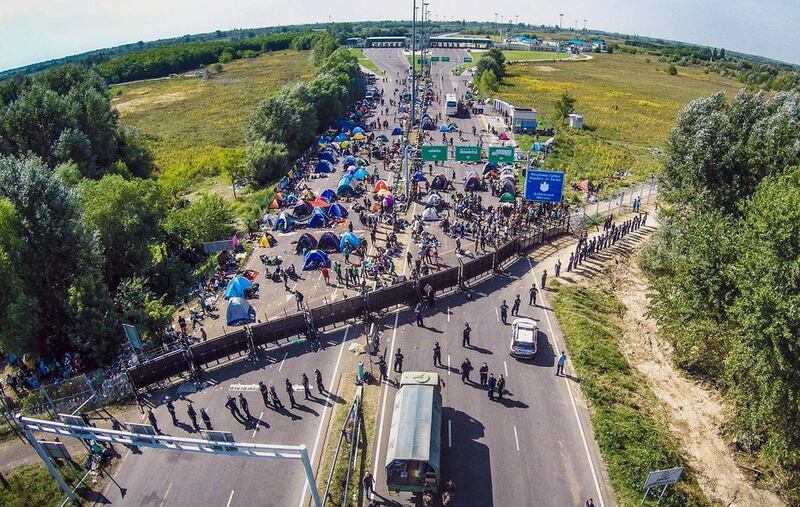 Migrants camping on the border between Hungary and Serbia near Roeszke. Istvan Ruzsa / AFP Photo