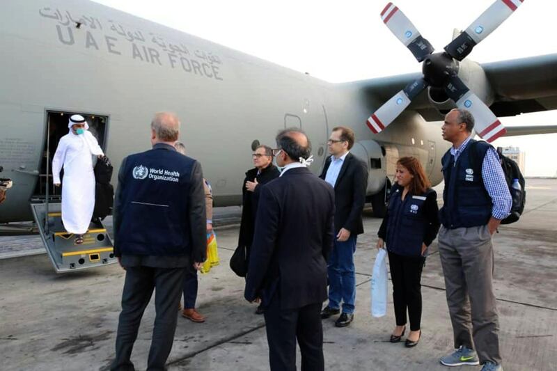 A handout picture released by the World Health Organization (WHO), shows people disembarking from a United Arab Emirates military transport plane, used to transport medical equipment and coronavirus testing kits provided by the World Health Organisation, upon their arrival in Iran. AFP