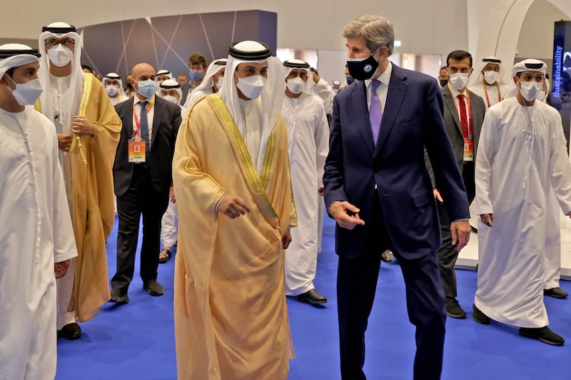 Sheikh Mansour bin Zayed, Deputy Prime Minister and Minister of Presidential Affairs, tours with John Kerry, the US president's climate envoy, the Global Manufacturing and Industrialisation (GMIS) Summit in Dubai on November 22, 2021.  AFP