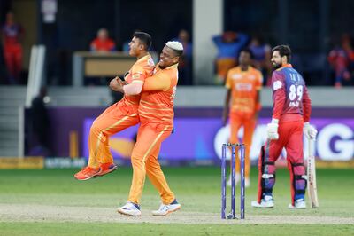 Aayan Khan of Gulf Giants is hoisted up by Shimron Hetmyer after taking the wicket of Raja Akifullah Khan of Dubai Capitals. ILT20