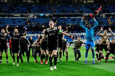 Ajax's players celebrate in front of their fans after beating Real Madrid. AFP