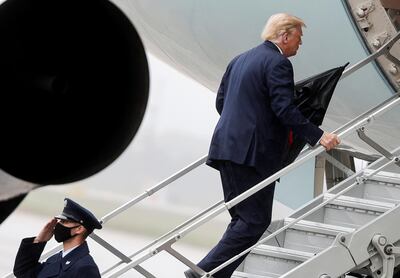 A member of the ground crew wearing a protective face mask salutes U.S. President Donald Trump as he boards Air Force One while departing Washington for travel to Florida, his first campaign trip since being treated for the coronavirus disease (COVID-19), at Joint Base Andrews, Maryland, U.S., October 12, 2020. REUTERS/Carlos Barria