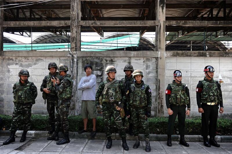 Thai soldiers stand outside a closed polling station in central Bangkok. The election commission said the closure of polls affected more than 6 million registered voters.  AFP 

