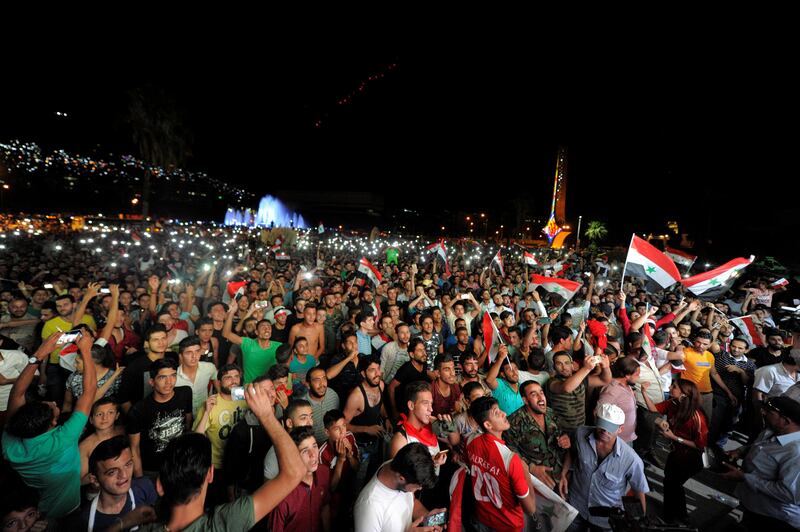 Syrian government backers and rebel supporters alike roared with joy on Tuesday when Omar Al Soma scored a 93rd-minute goal, giving their national team a 2-2 draw with Iran. Omar Sanadiki / Reuters