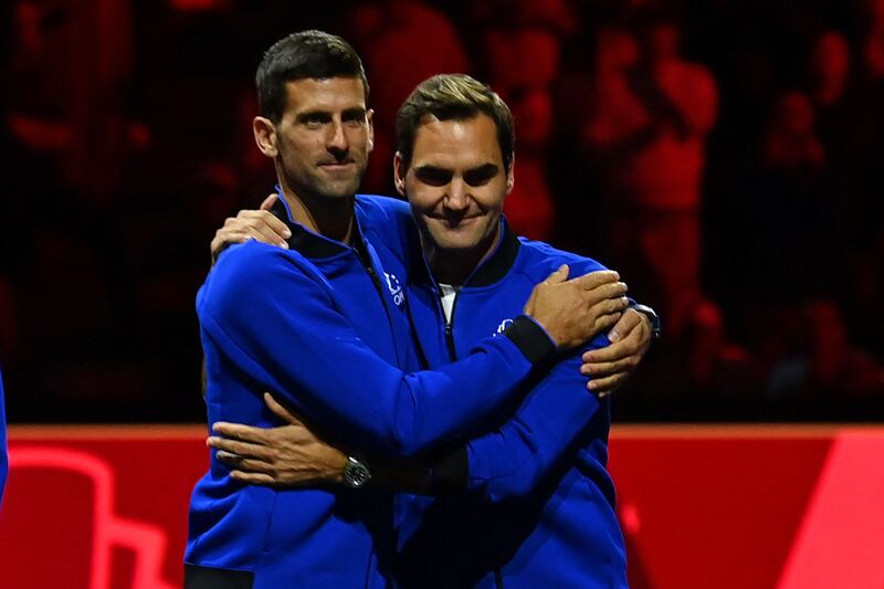 Novak Djokovic embraces Switzerland's Roger Federer at the presentation ceremony. AFP