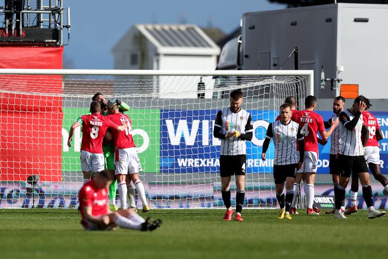Ben Foster of Wrexham is congratulated by teammates after the final whistle after saving a 97th minute Notts County penalty in the Vanarama National League match at The Racecourse on April 10, 2023 in Wrexham, Wales. Wrexham won the game 3-2. Getty Images