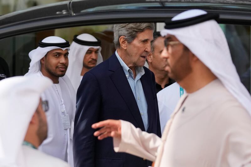 Mr Kerry entering the Cop28 venue, Expo City Dubai. AP