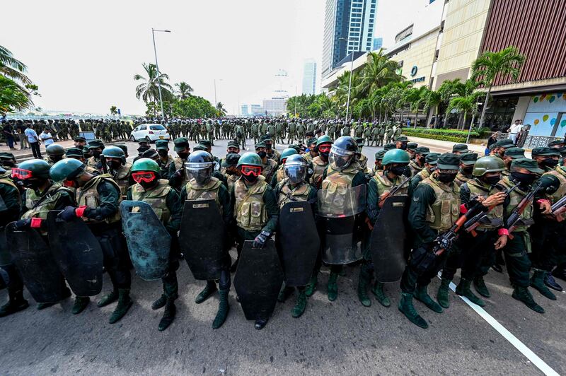 Army personnel stand guard outside the president's office in Colombo. AFP