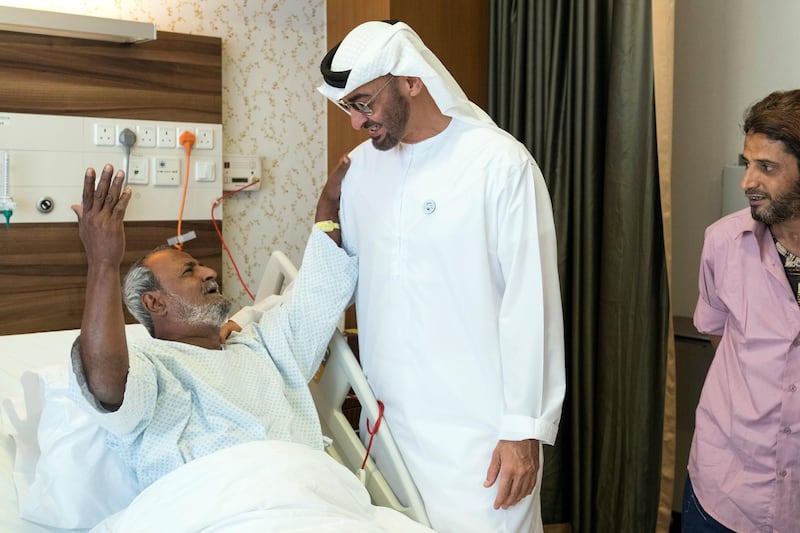 ABU DHABI, UNITED ARAB EMIRATES -  March 11, 2018: HH Sheikh Mohamed bin Zayed Al Nahyan, Crown Prince of Abu Dhabi and Deputy Supreme Commander of the UAE Armed Forces (2nd L), listens to a poem, while visiting Fadel Mahmoud Saleh (L), who is in Abu Dhabi receiving medical assistance at Burjeel Hospital. 
( Ryan Carter for the Crown Prince Court - Abu Dhabi )
---