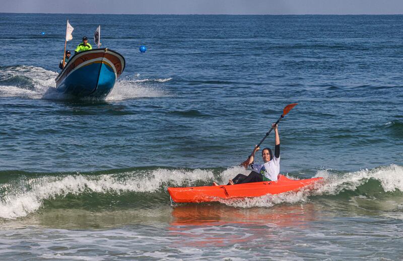 A Palestinian woman takes part in a local canoeing championship, off the coast of Gaza city.