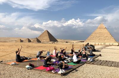 Women attend a Yes Yoga Day event in support of the eradication of violence against women amid the coronavirus disease (COVID-19) in front of the historical Giza pyramids, Egypt, November 7, 2020. REUTERS/Ahmed Fahmy