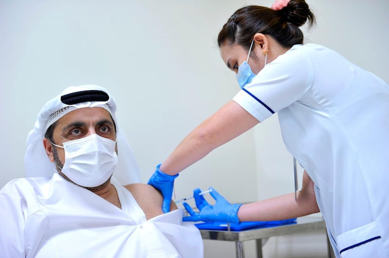 Khalifa bin Dary, executive director of Dubai Ambulance Services Corporation, receives his first dose of the Pfizer-BioNTech vaccine. Courtesy: Dubai Media Office