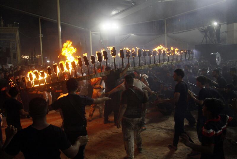 Shiites perform mourning rituals during the period of Ashura in the Iraqi holy city of Najaf during the night. AFP
